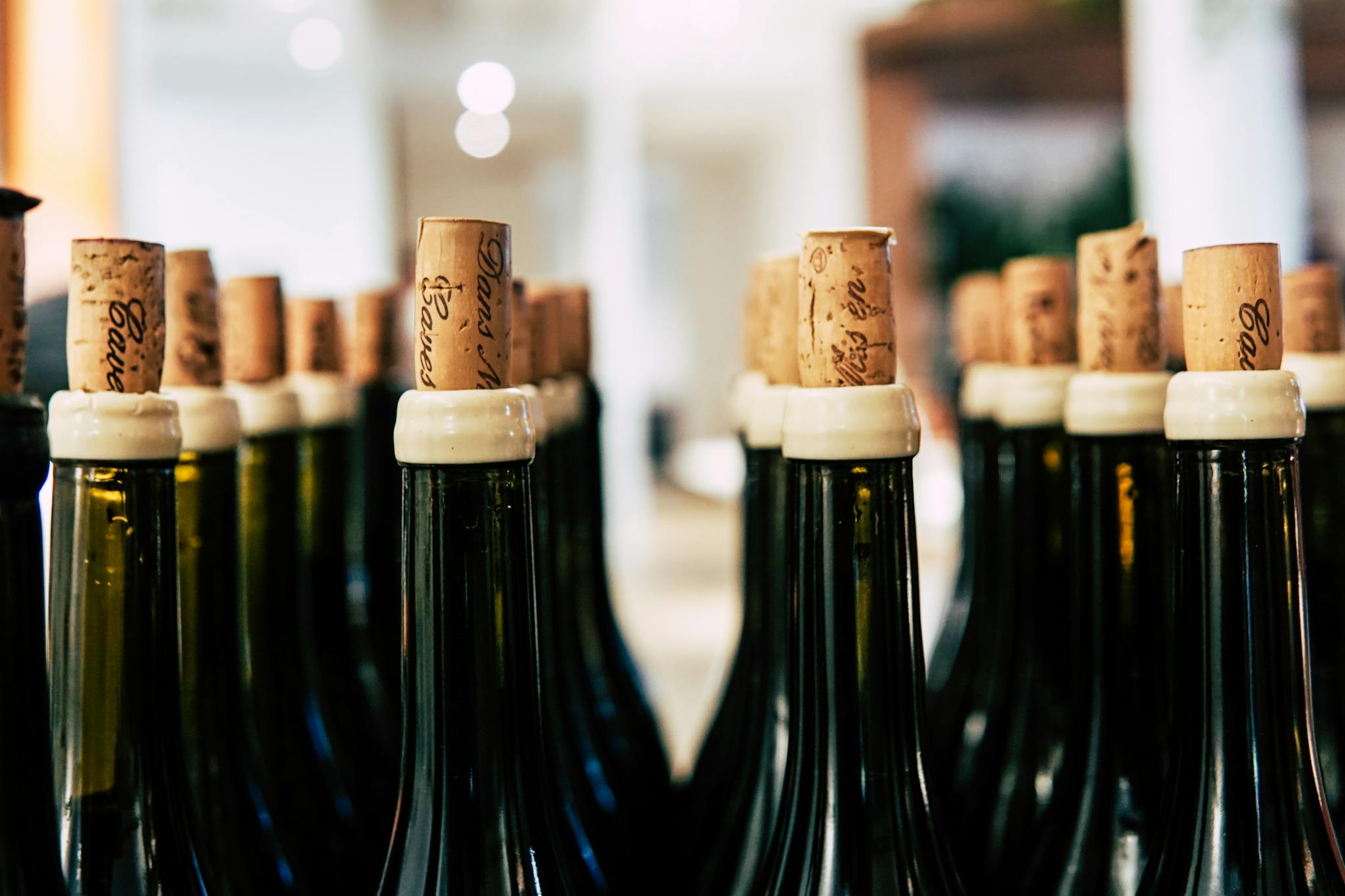 A detailed shot of wine bottles corked and ready for storage, perfect for beverage-themed content.
